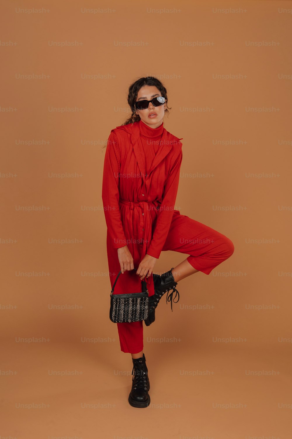 a woman wearing a red outfit and sunglasses