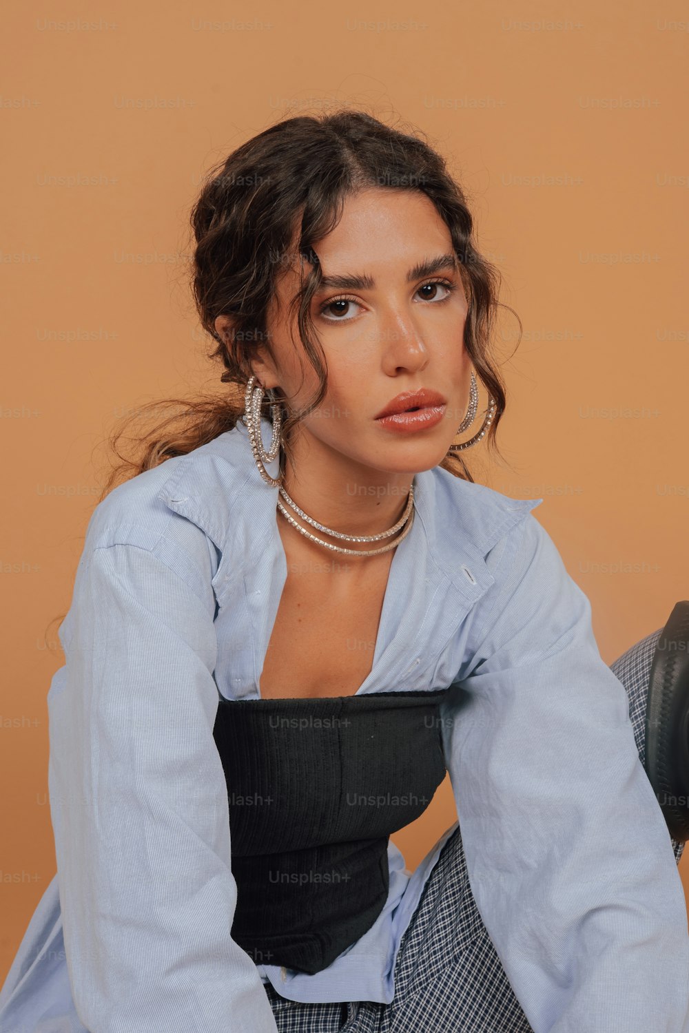 a woman sitting on a chair with her hands on her knees