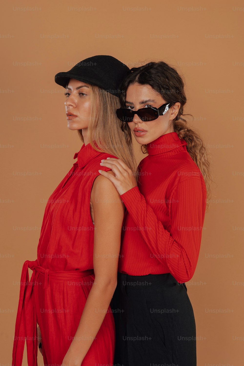 two women in red shirts and black pants