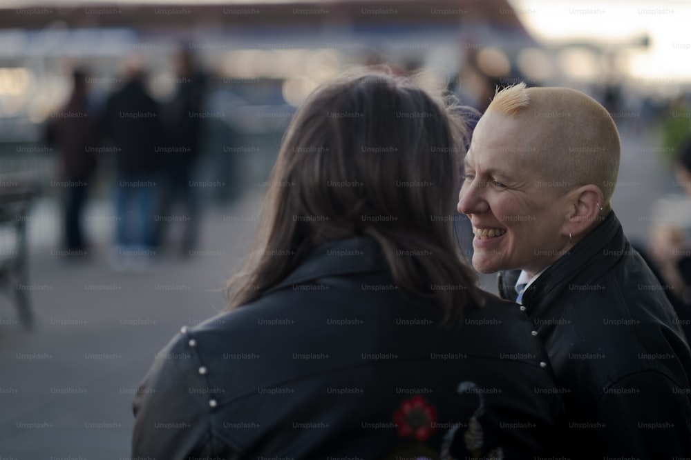 a man with a bald head talking to a woman