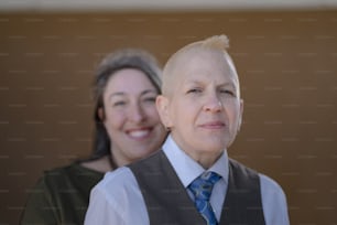 a woman standing next to a man in a suit and tie