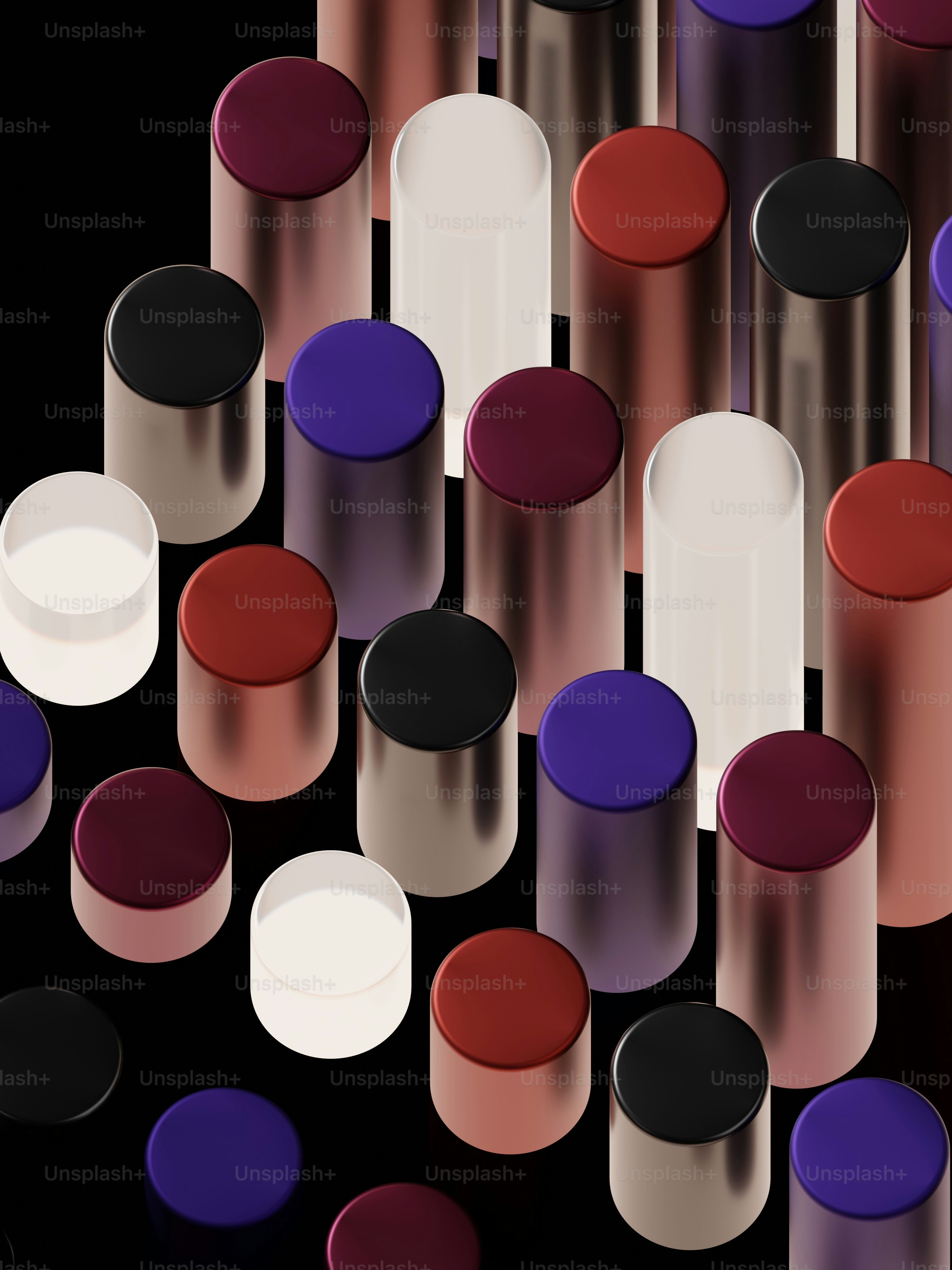 a group of different colored bottles on a black surface