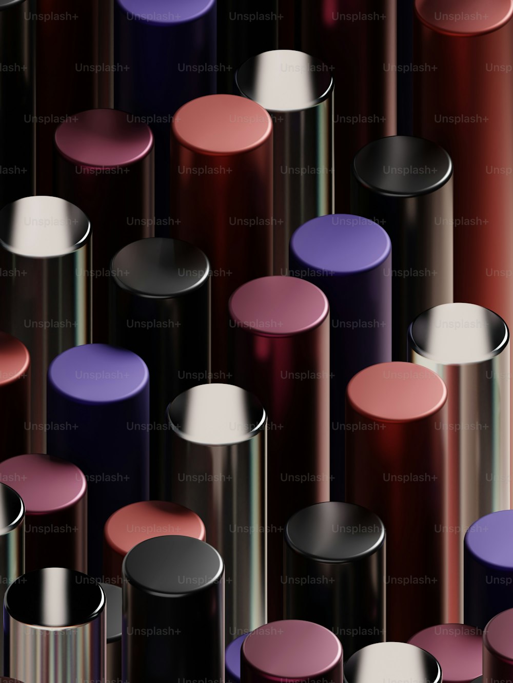 a group of purple and pink lipsticks on a black background