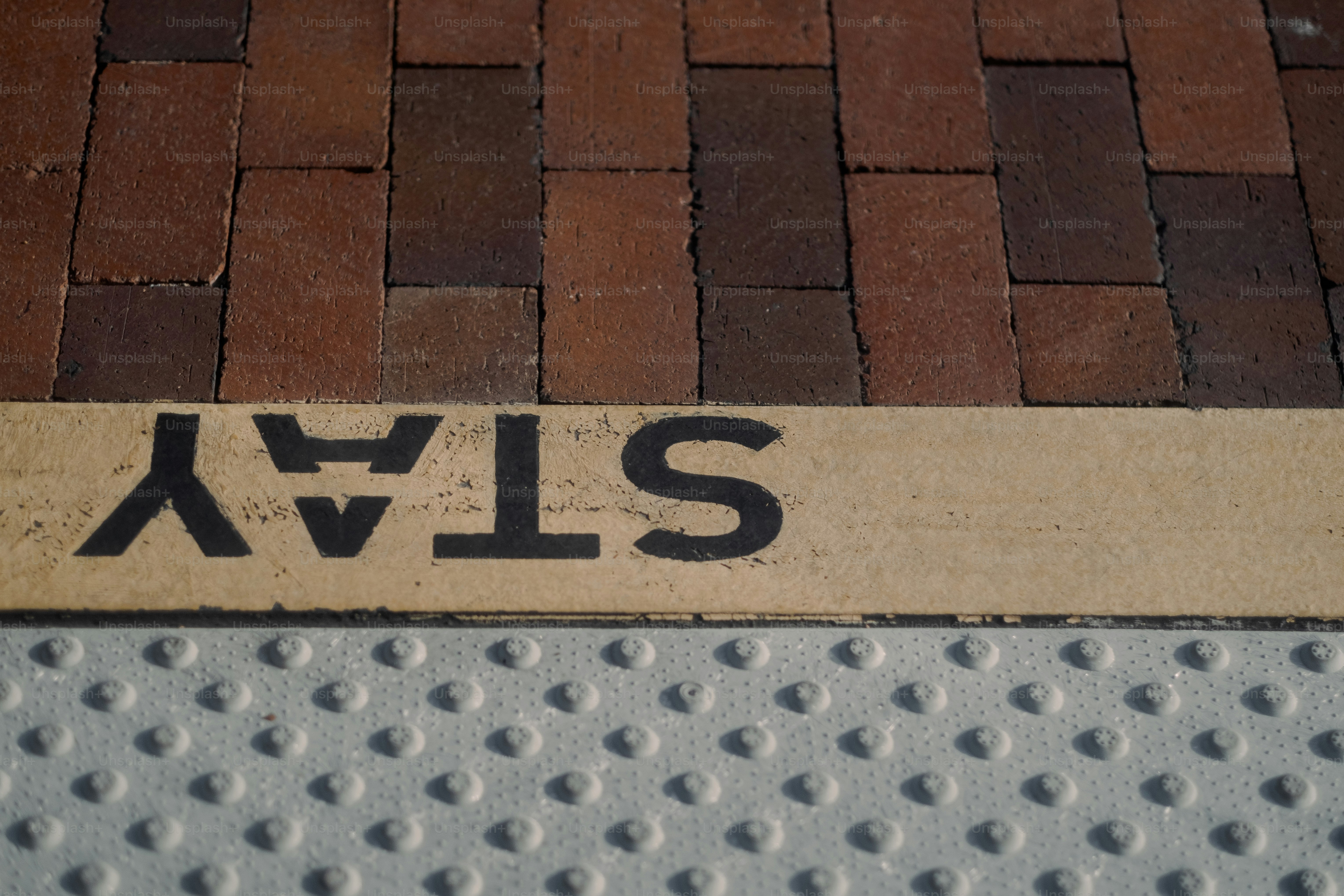 Warning pavers and part of 'stay behind the yellow line' at a metro station in Los Angeles.
