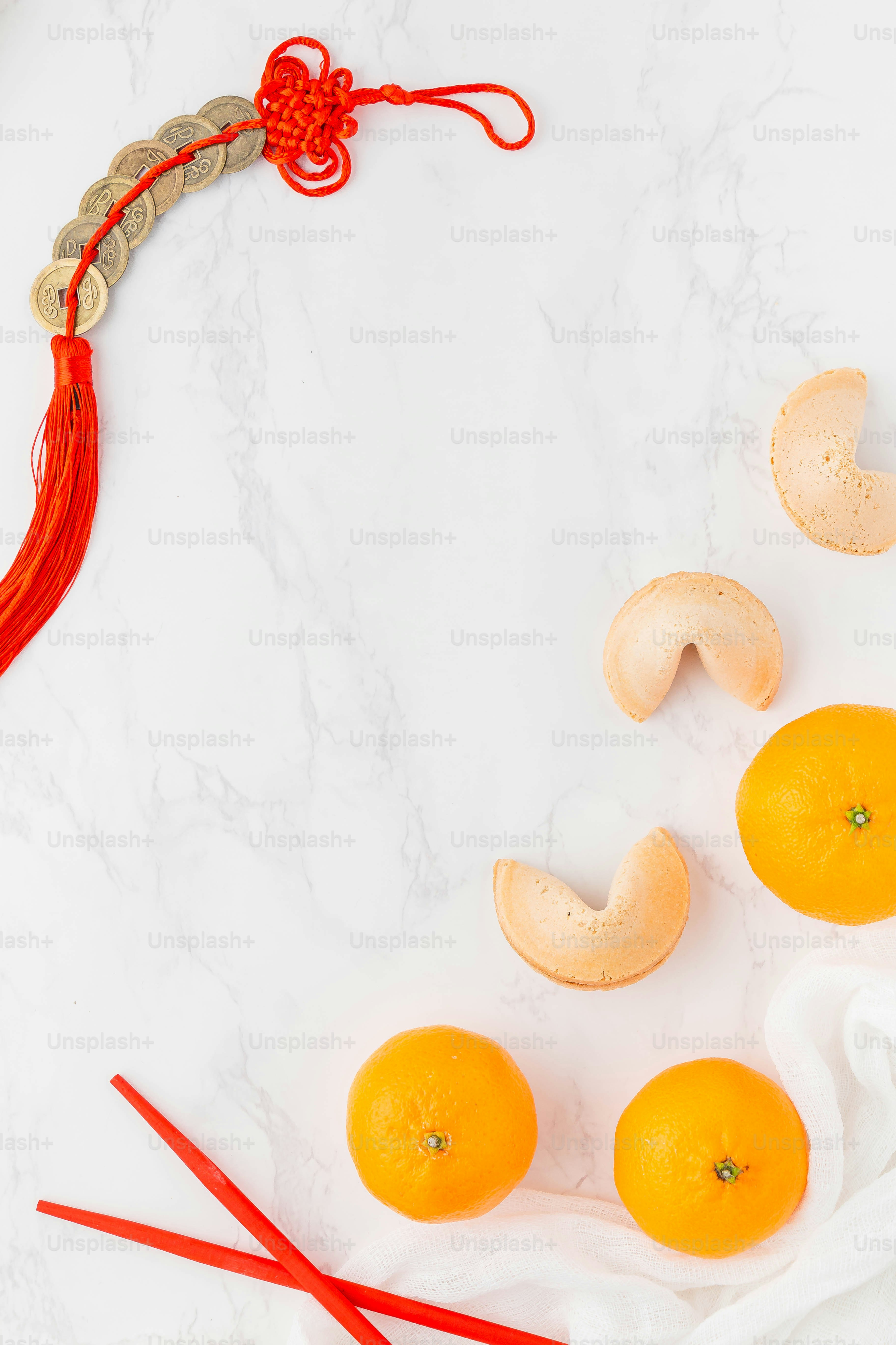 a white marble table topped with oranges and chopsticks