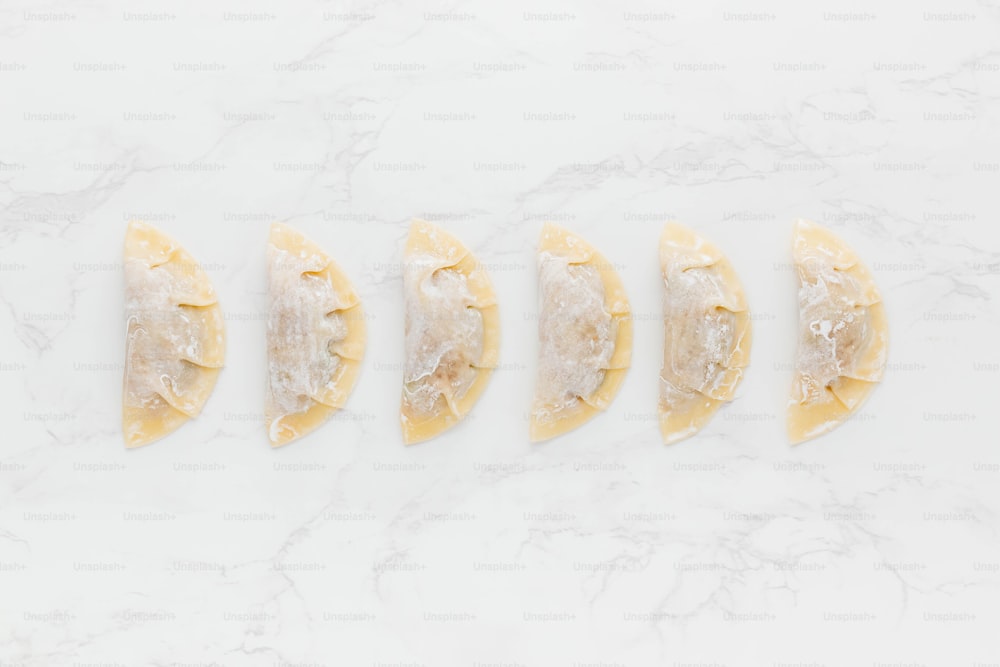 a white marble counter top with slices of food on it