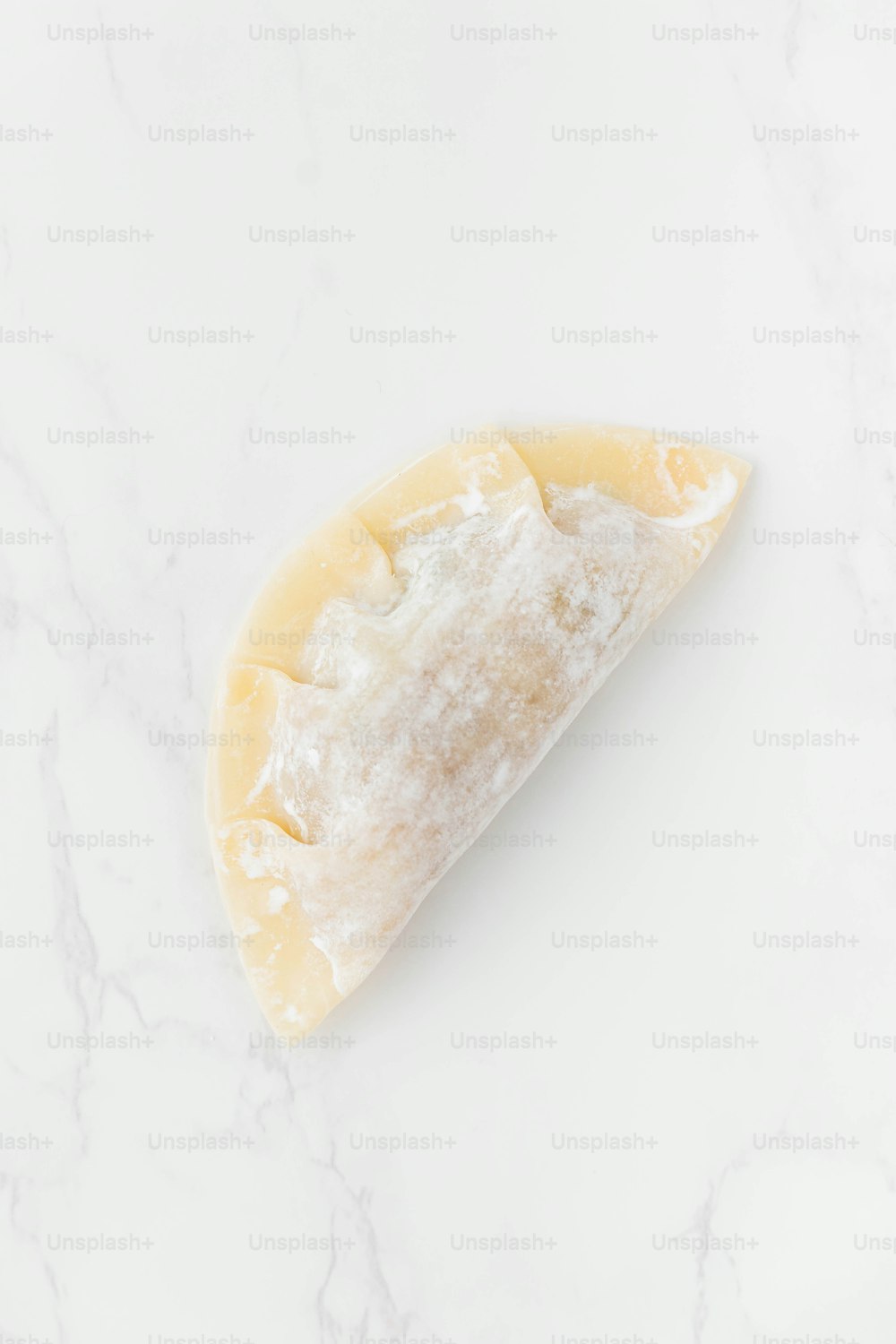 a piece of cheese sitting on top of a white counter