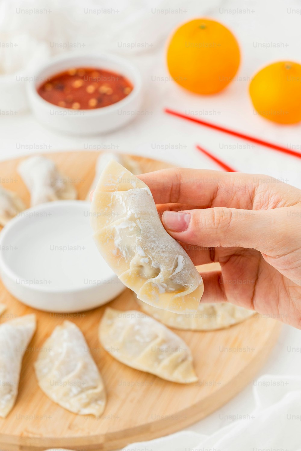 a person is holding a dumpling in their hand