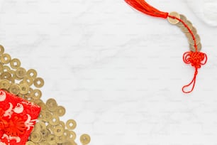 a red and gold necklace with a red tassel
