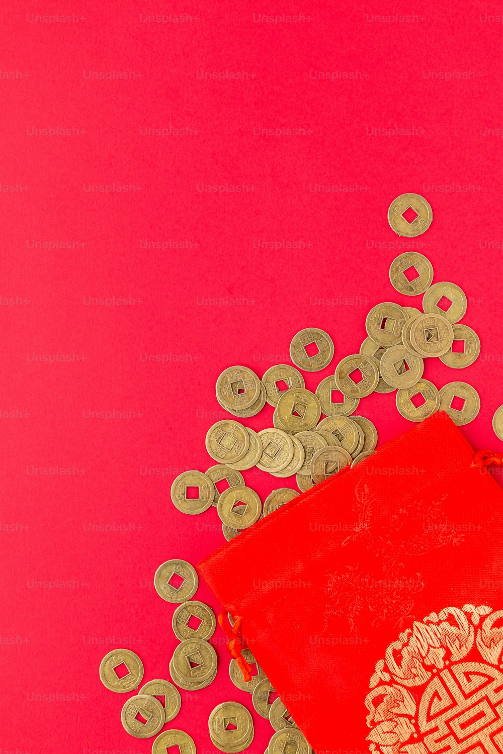 a red bag sitting on top of a pile of coins