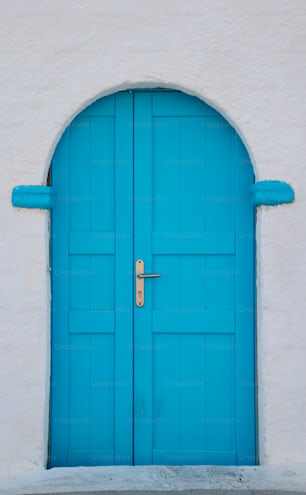 a blue door is open on a white building