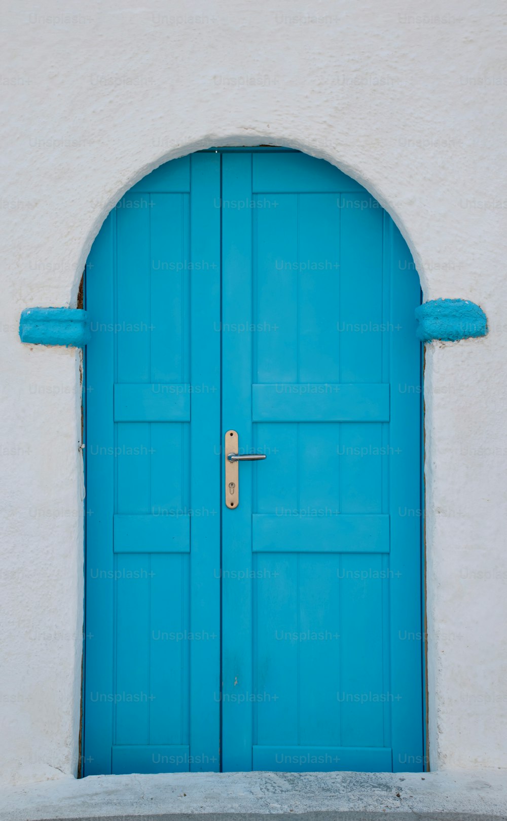 a blue door is open on a white building