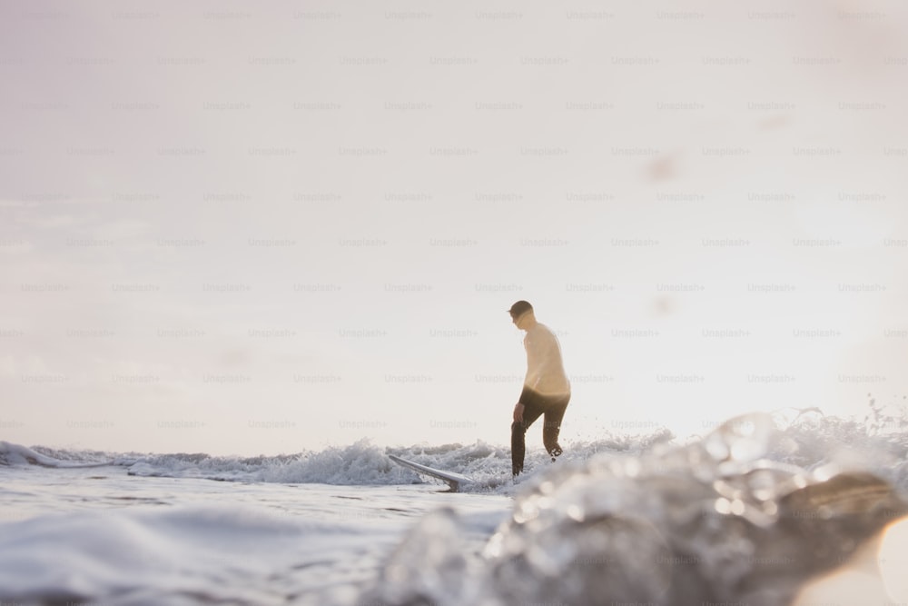 a man riding a wave on top of a surfboard