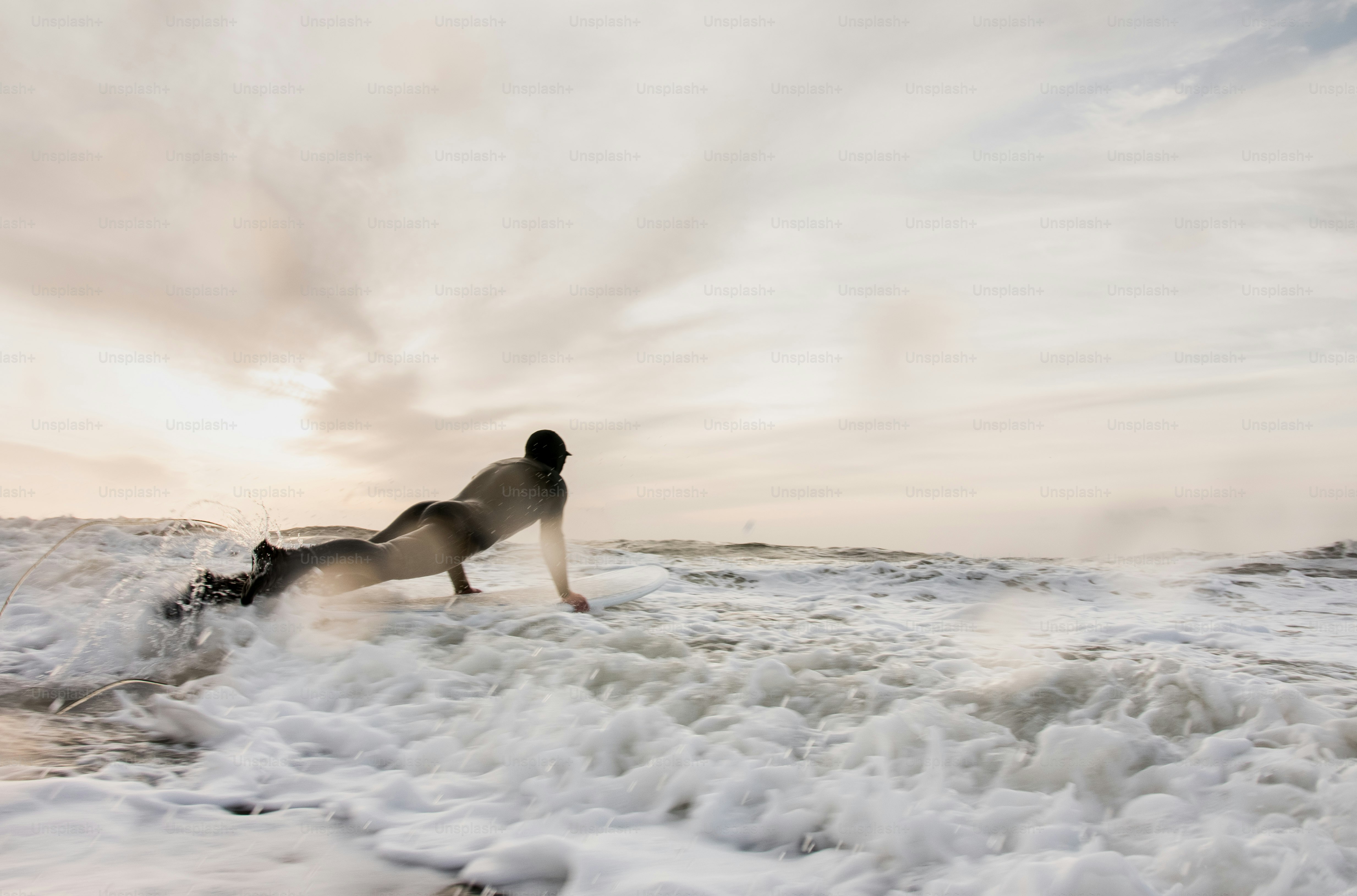 A man riding a wave on top of a surfboard photo – Winter Image on Unsplash