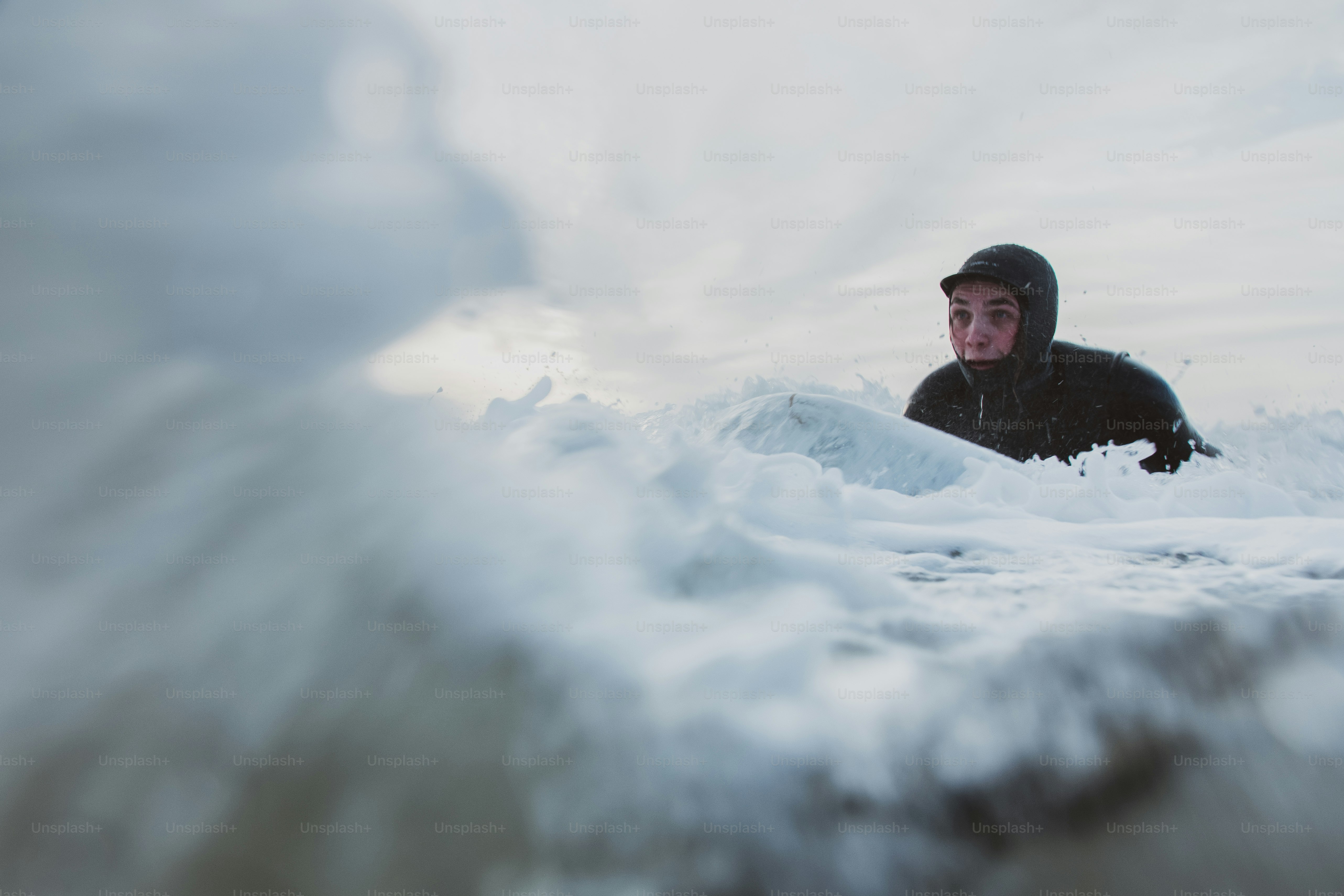 a man in a black jacket is in the water