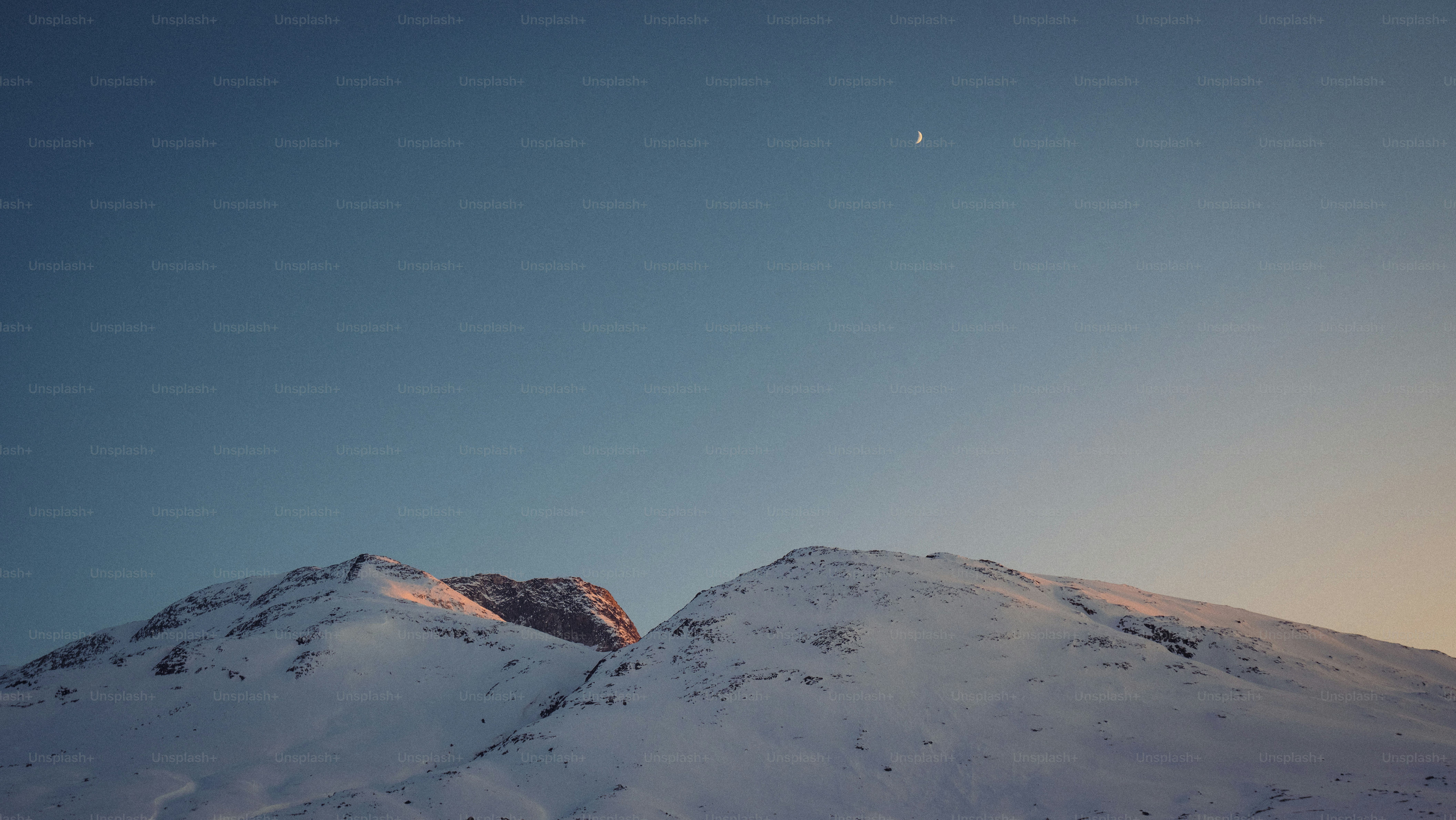 a snow covered mountain under a clear blue sky