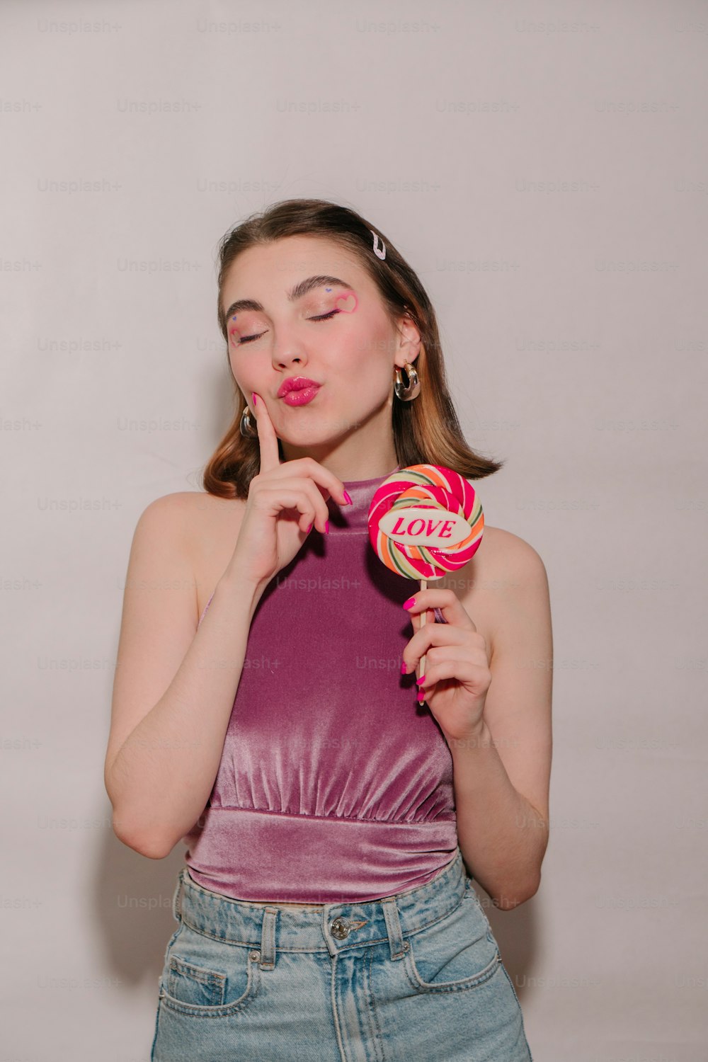 a woman holding a lollipop in her hands