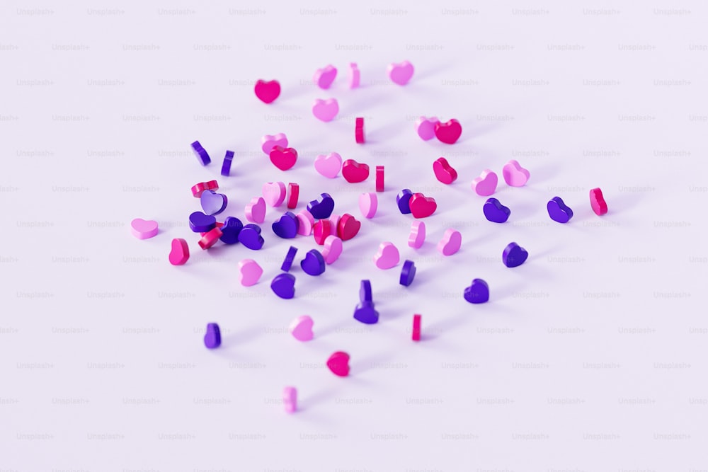 a pile of pink and purple confetti on a white surface