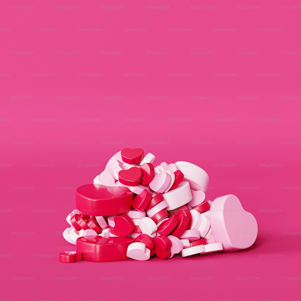 a pile of pink and white hearts on a pink background