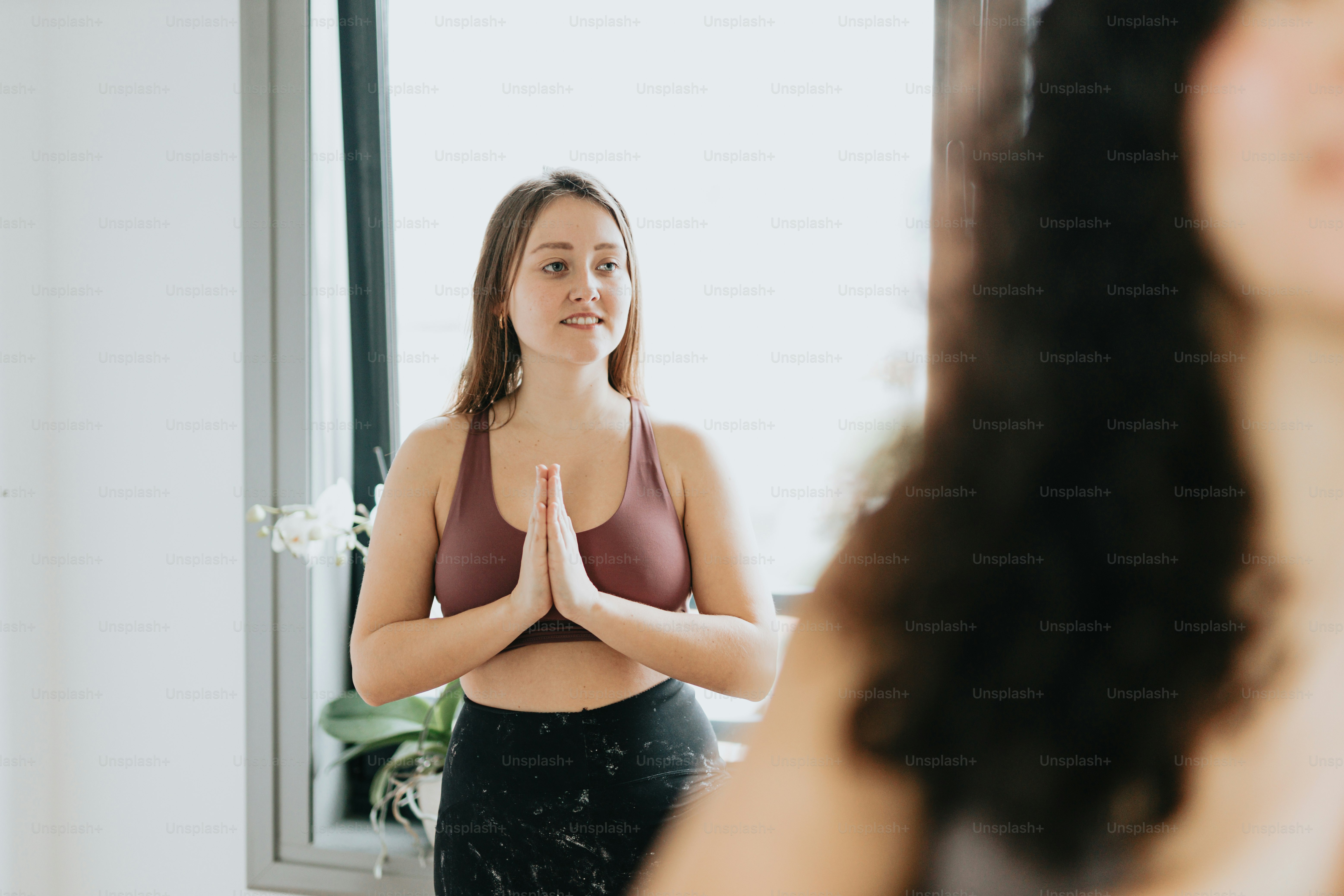 a woman standing in front of a mirror