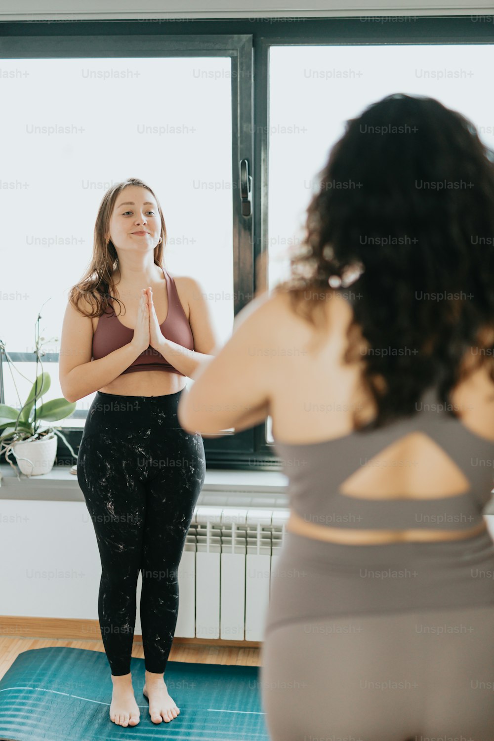 a woman standing in front of a mirror