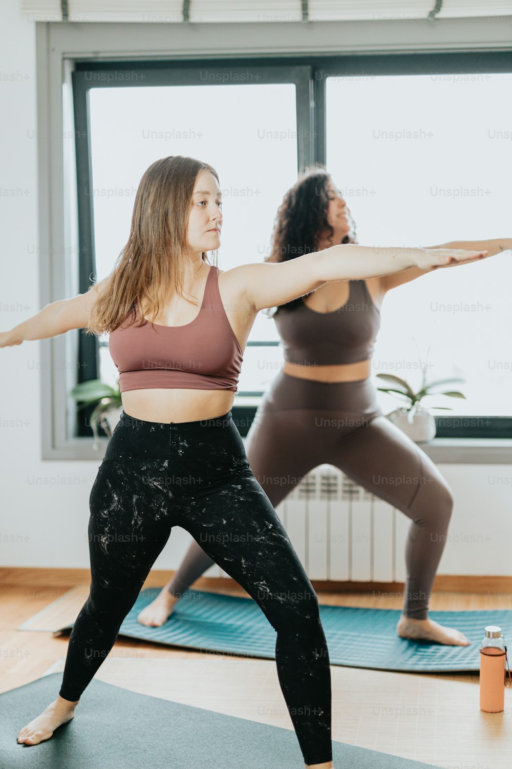 two women doing yoga in a room
