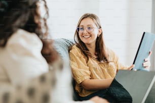 a woman sitting on a couch holding a book