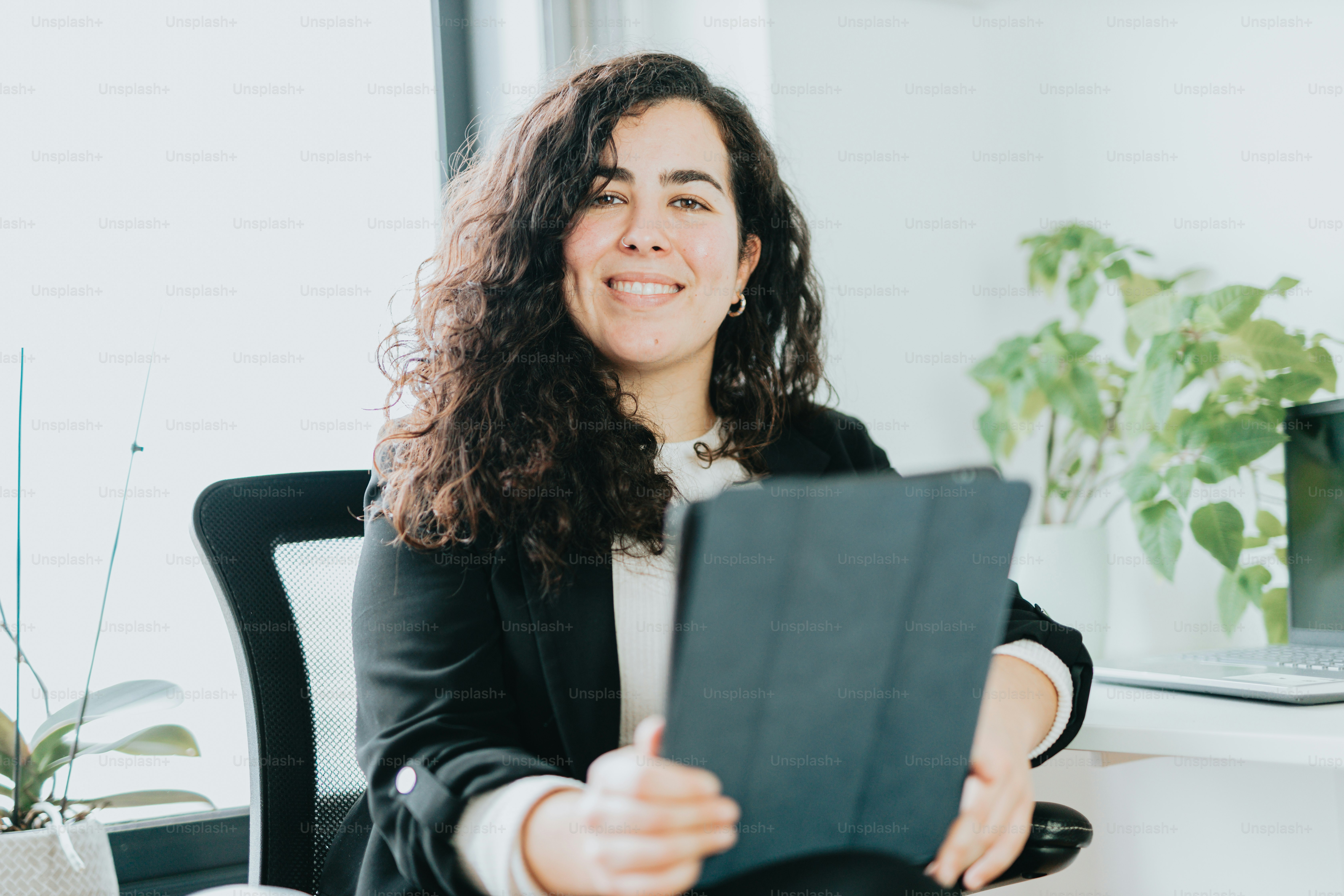 a woman sitting in a chair holding a piece of paper