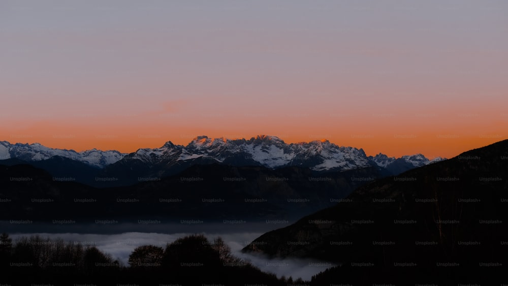 a view of a mountain range at sunset