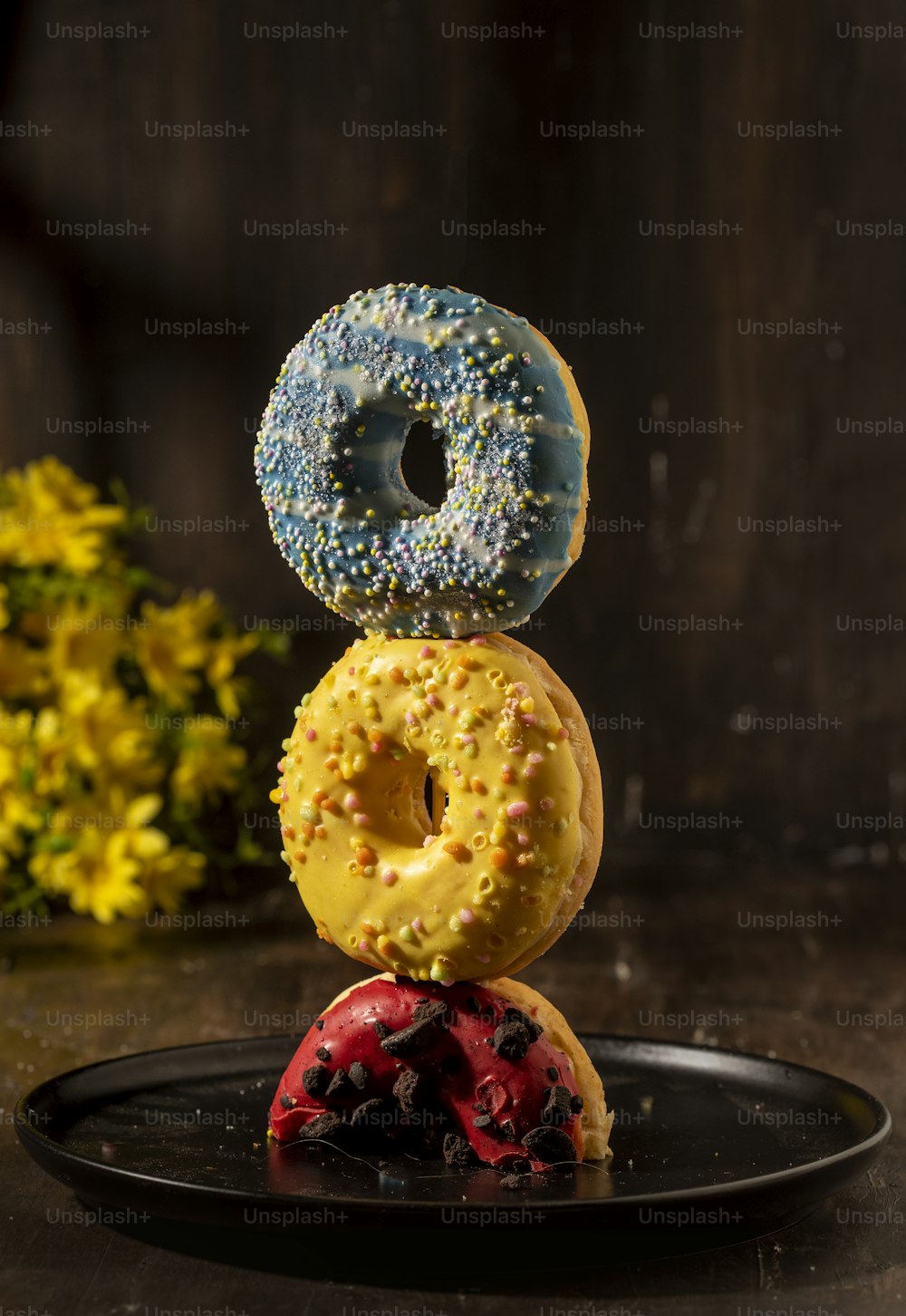 three donuts stacked on top of each other on a plate