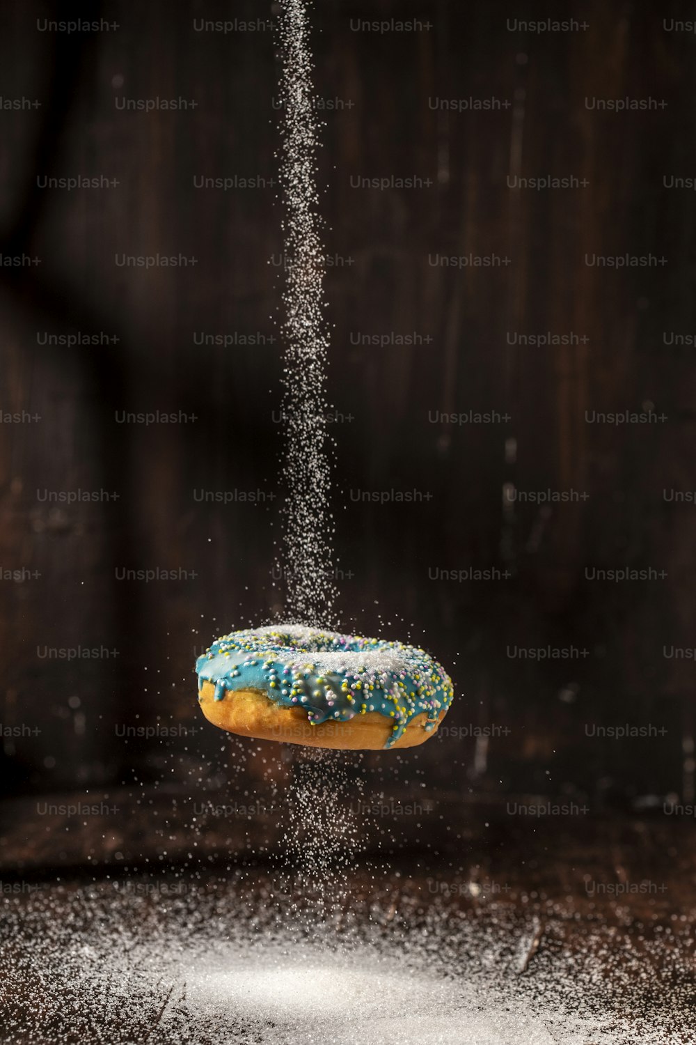 a donut is sprinkled with powder on a table