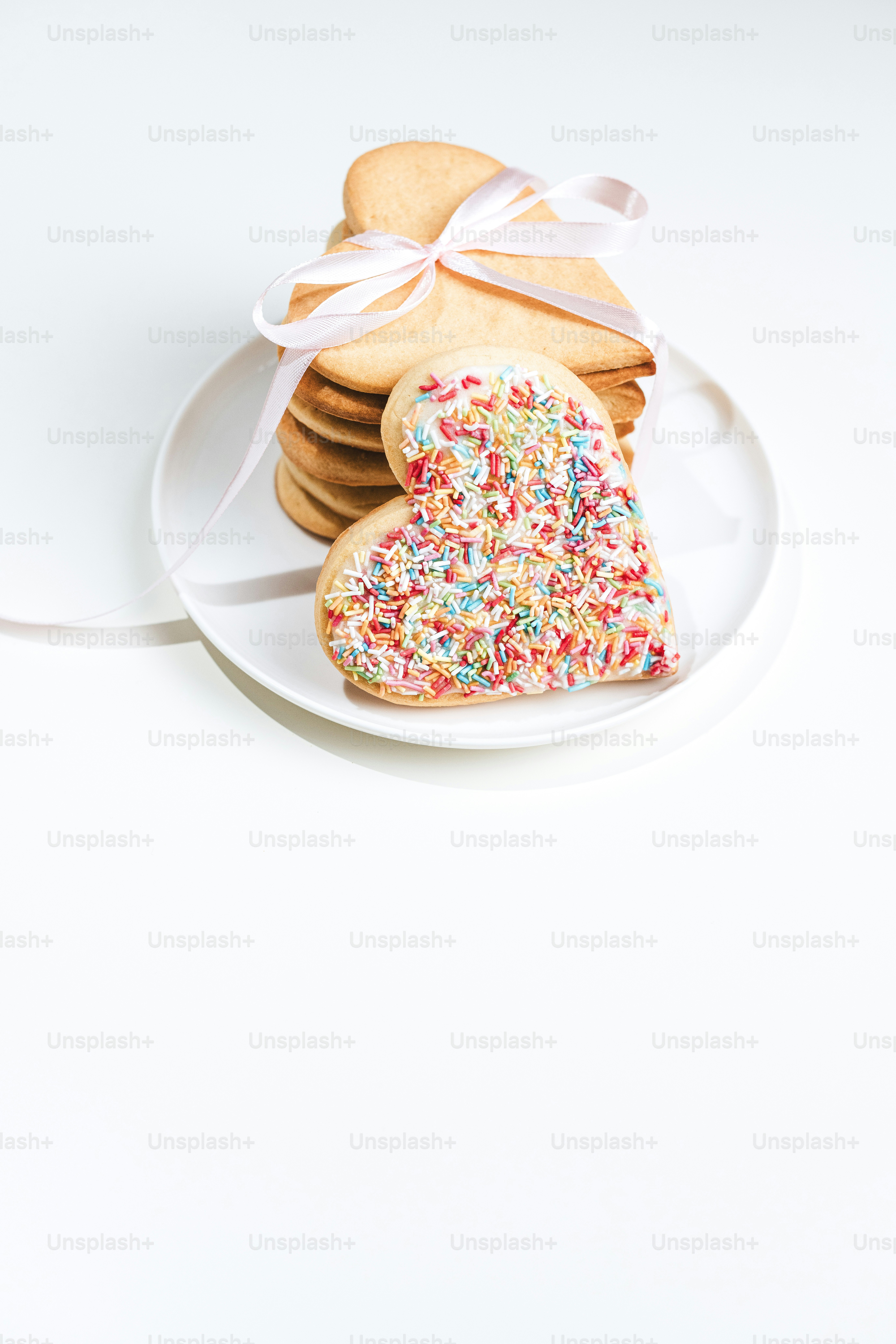 a white plate topped with cookies covered in sprinkles