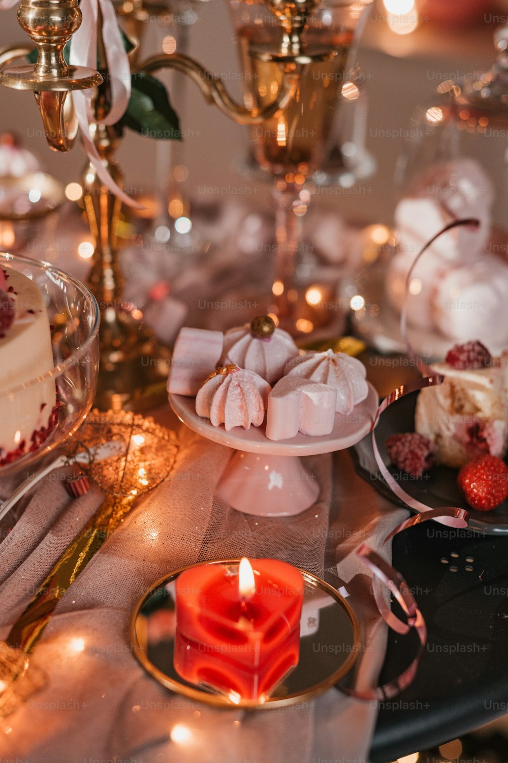 a table topped with a cake and a candle
