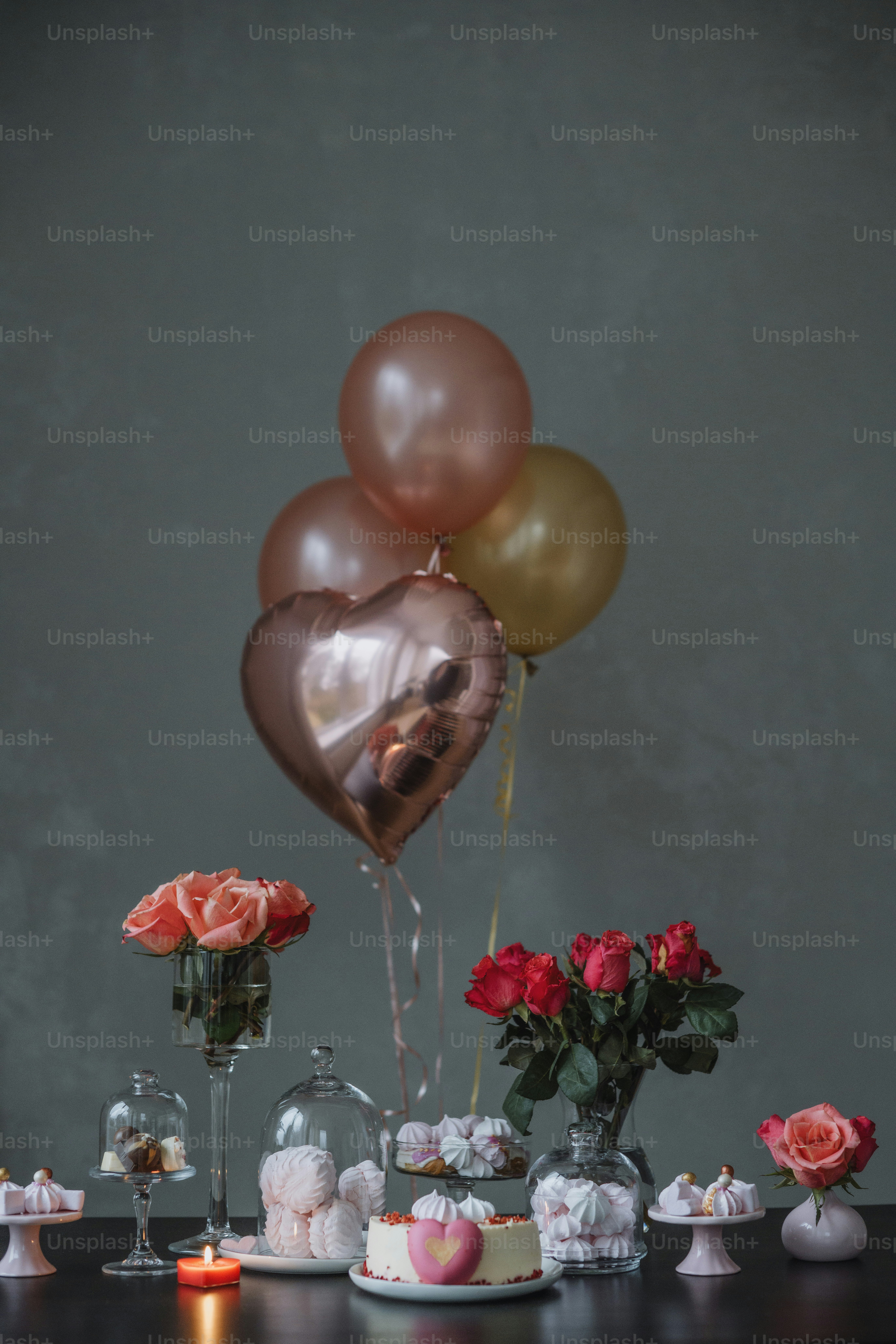 a table topped with lots of desserts and balloons