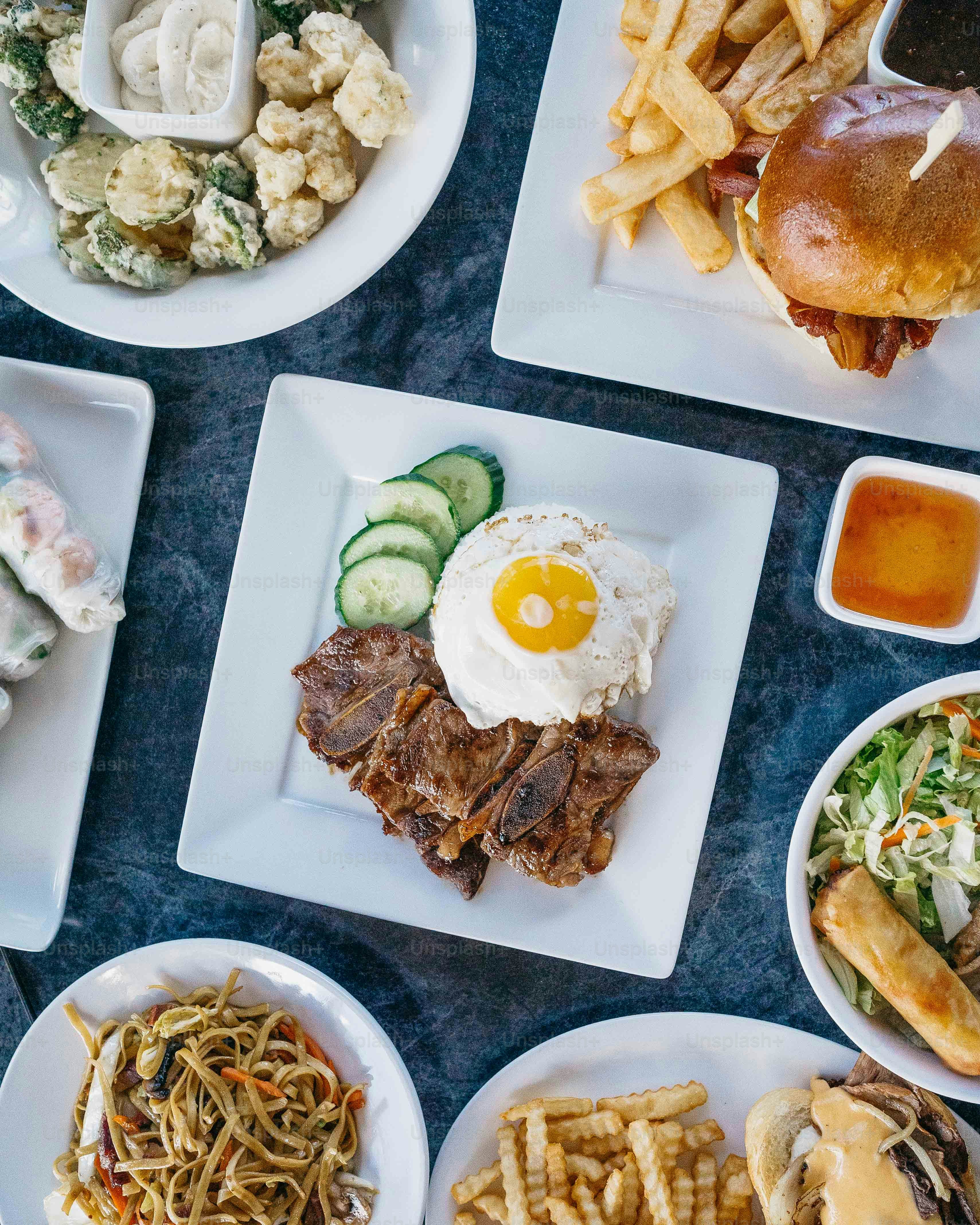 a table topped with plates filled with food