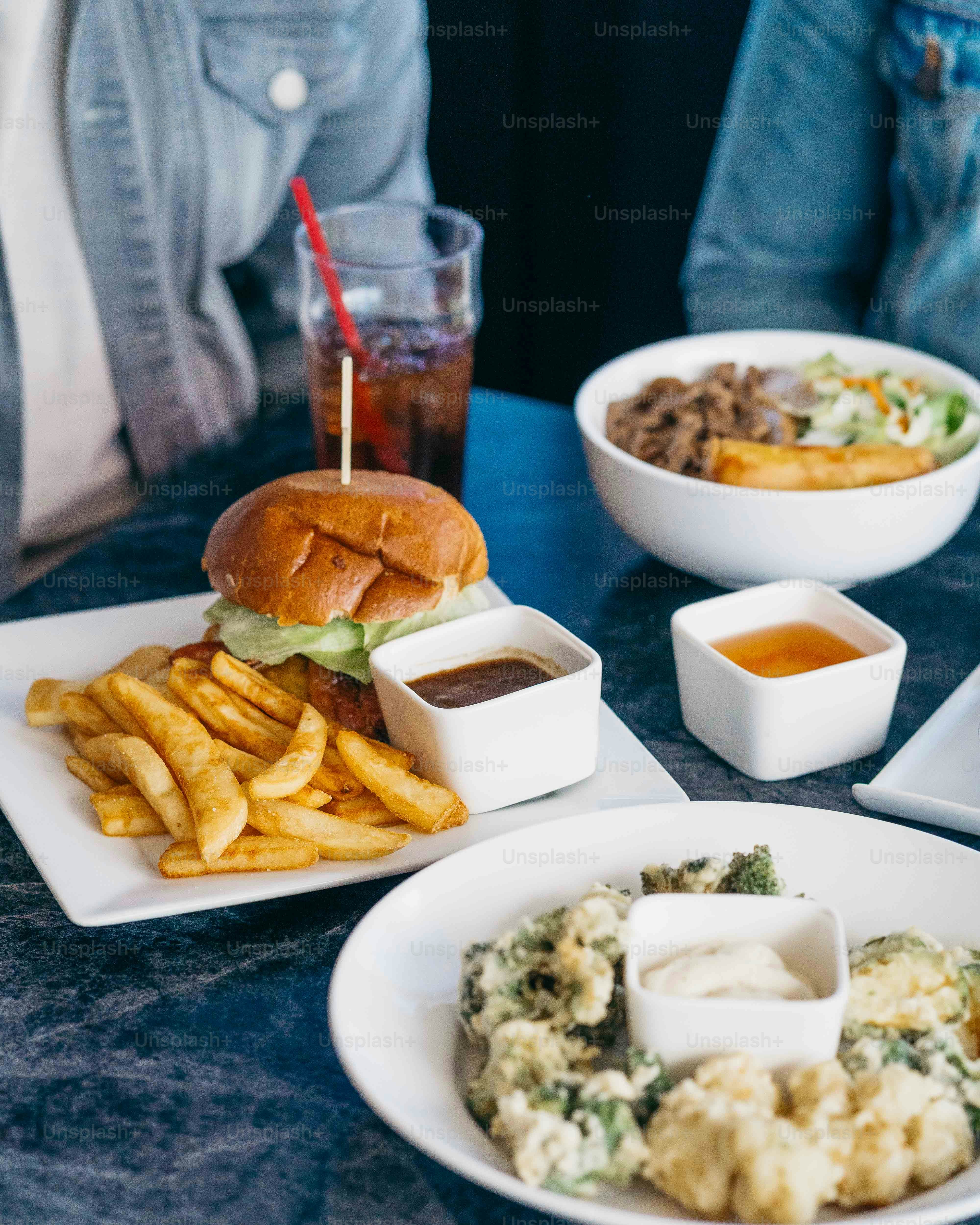 a table topped with plates of food and a drink