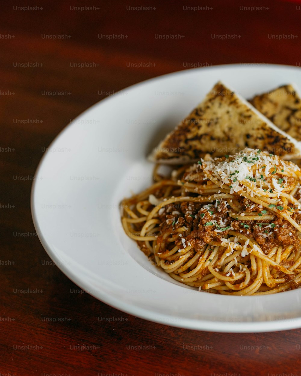 a white plate topped with pasta and tofu