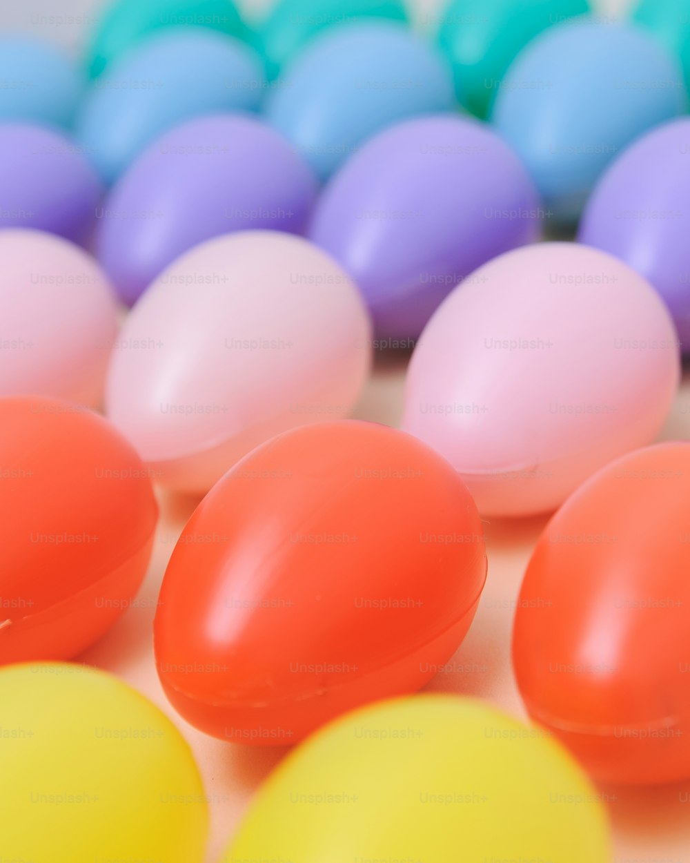 a group of colorful eggs sitting on top of a table