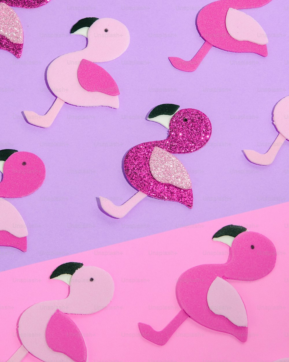 a pink and purple background with pink and white flamingos