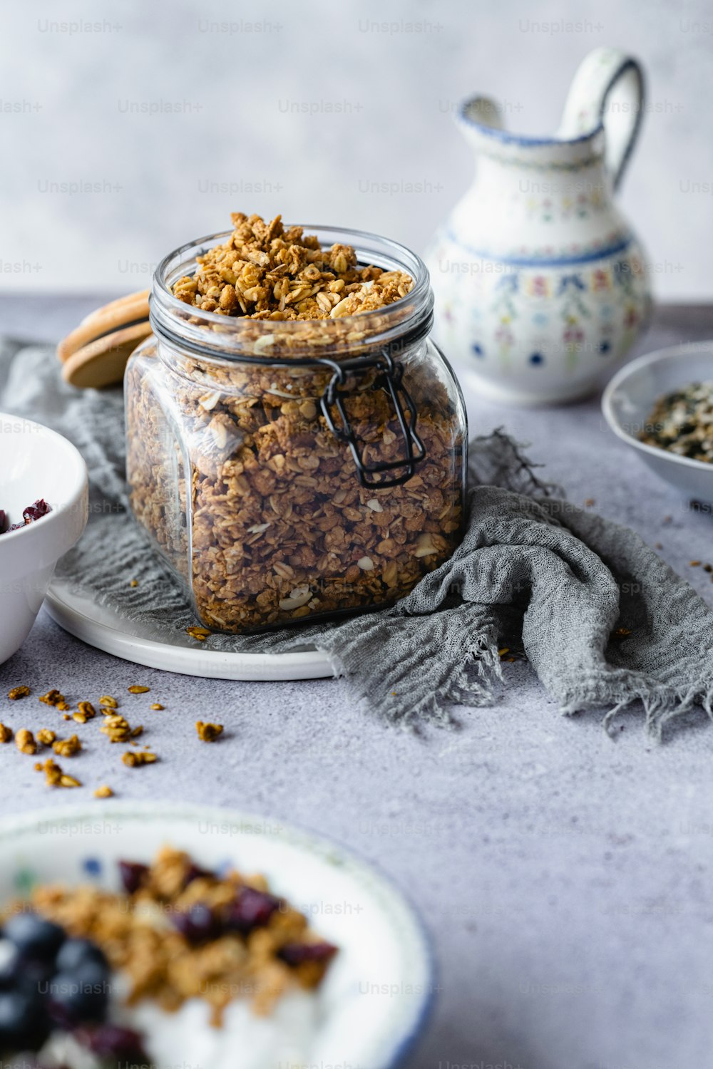 a glass jar filled with granola sitting on top of a table