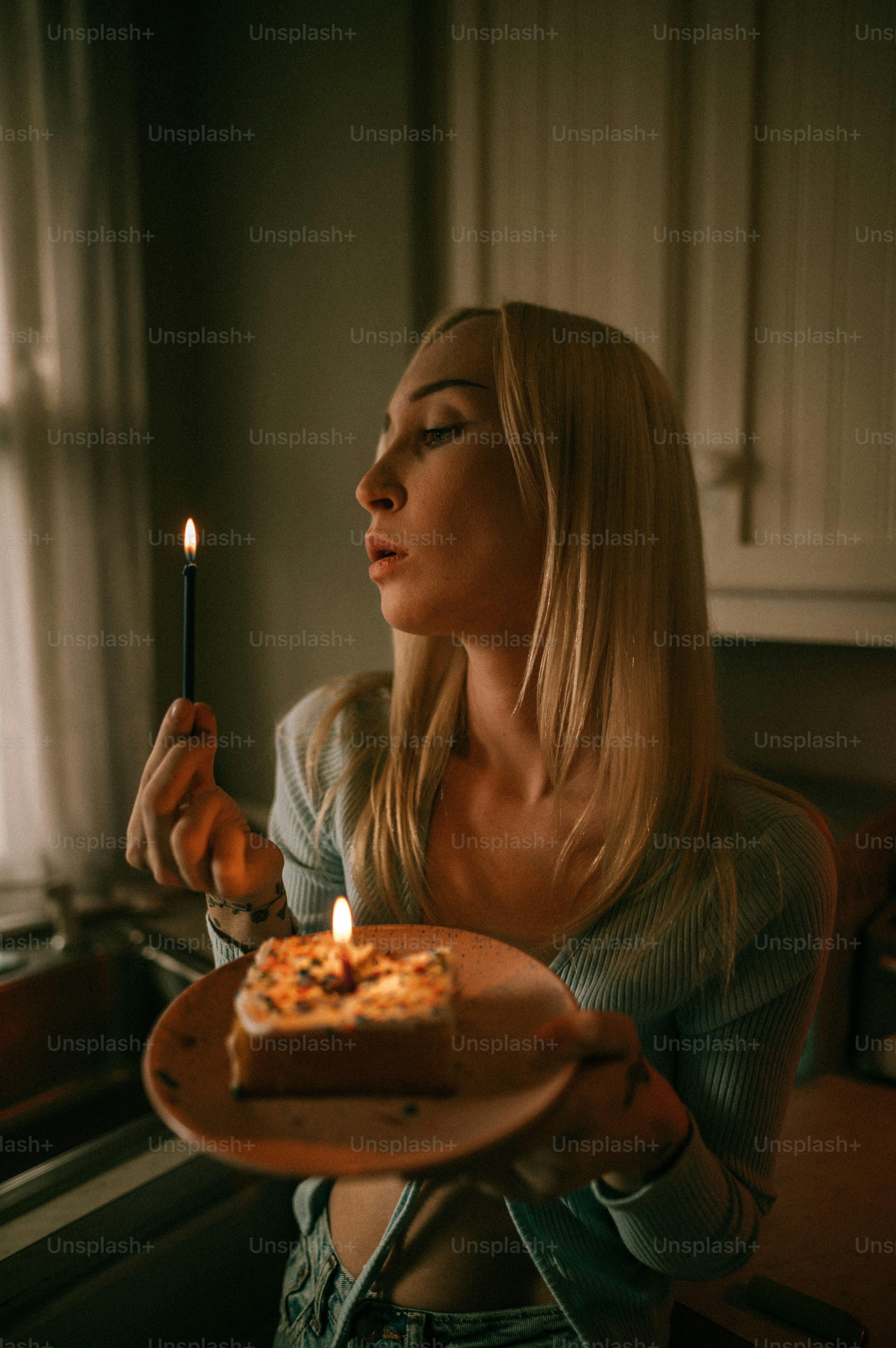 a woman holding a plate with a cake on it