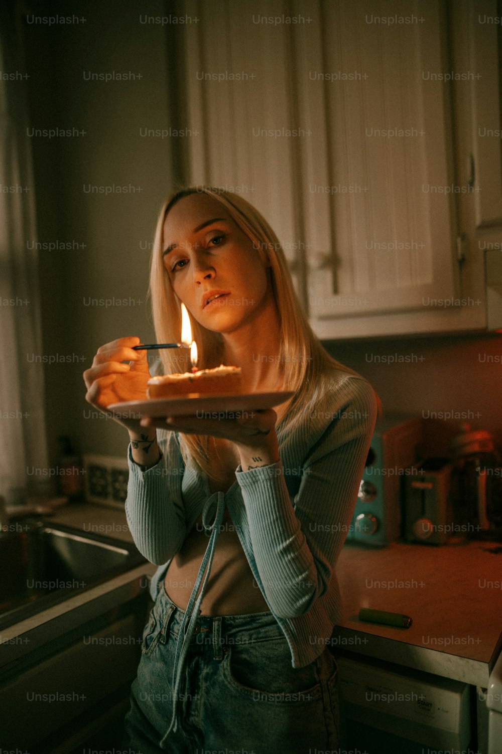 a woman holding a plate with a cake on it