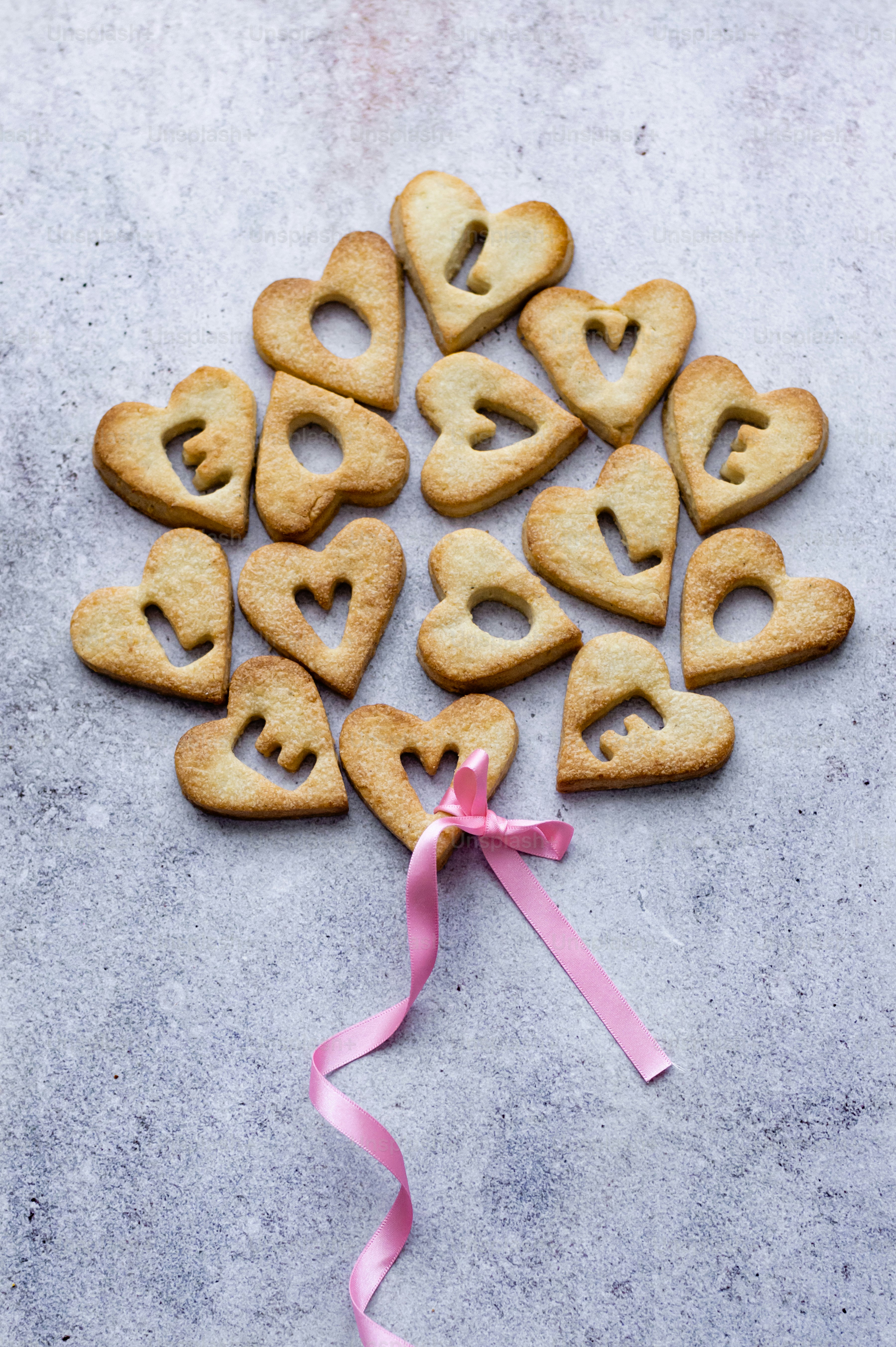 a bunch of heart shaped cookies on a table