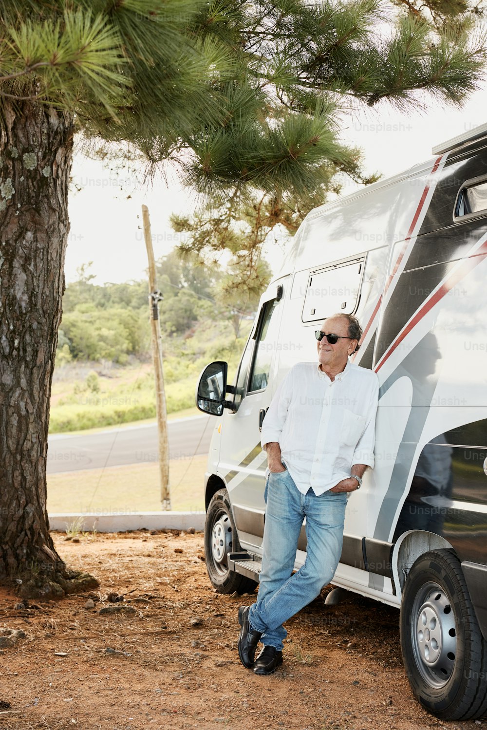 a man standing next to a parked motor home