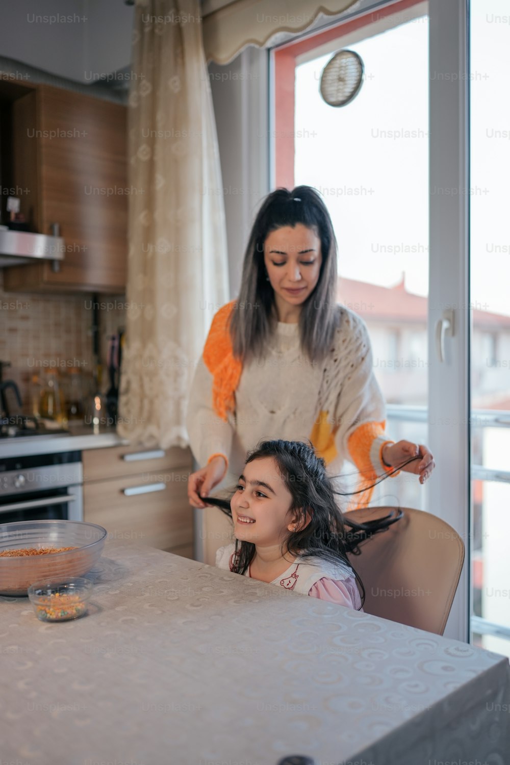 a woman and a girl sitting at a table