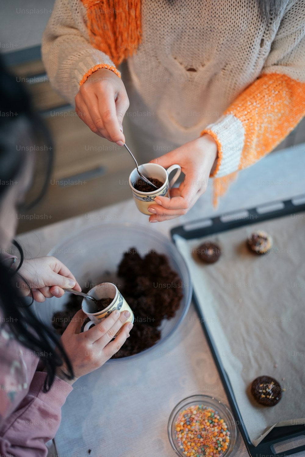 a woman is serving a cup of coffee to a child