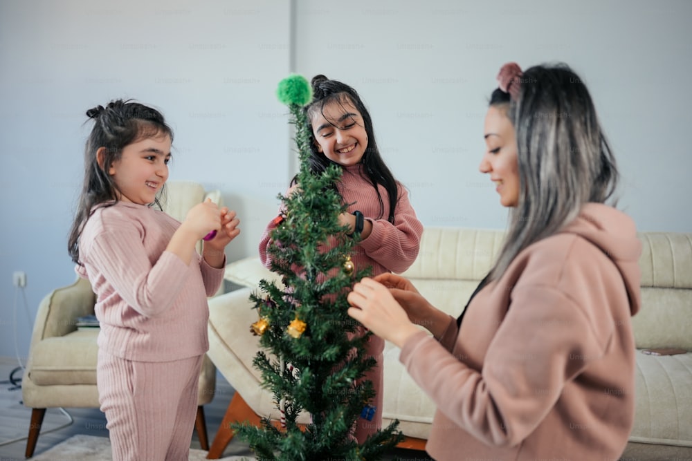 a group of women decorating a christmas tree