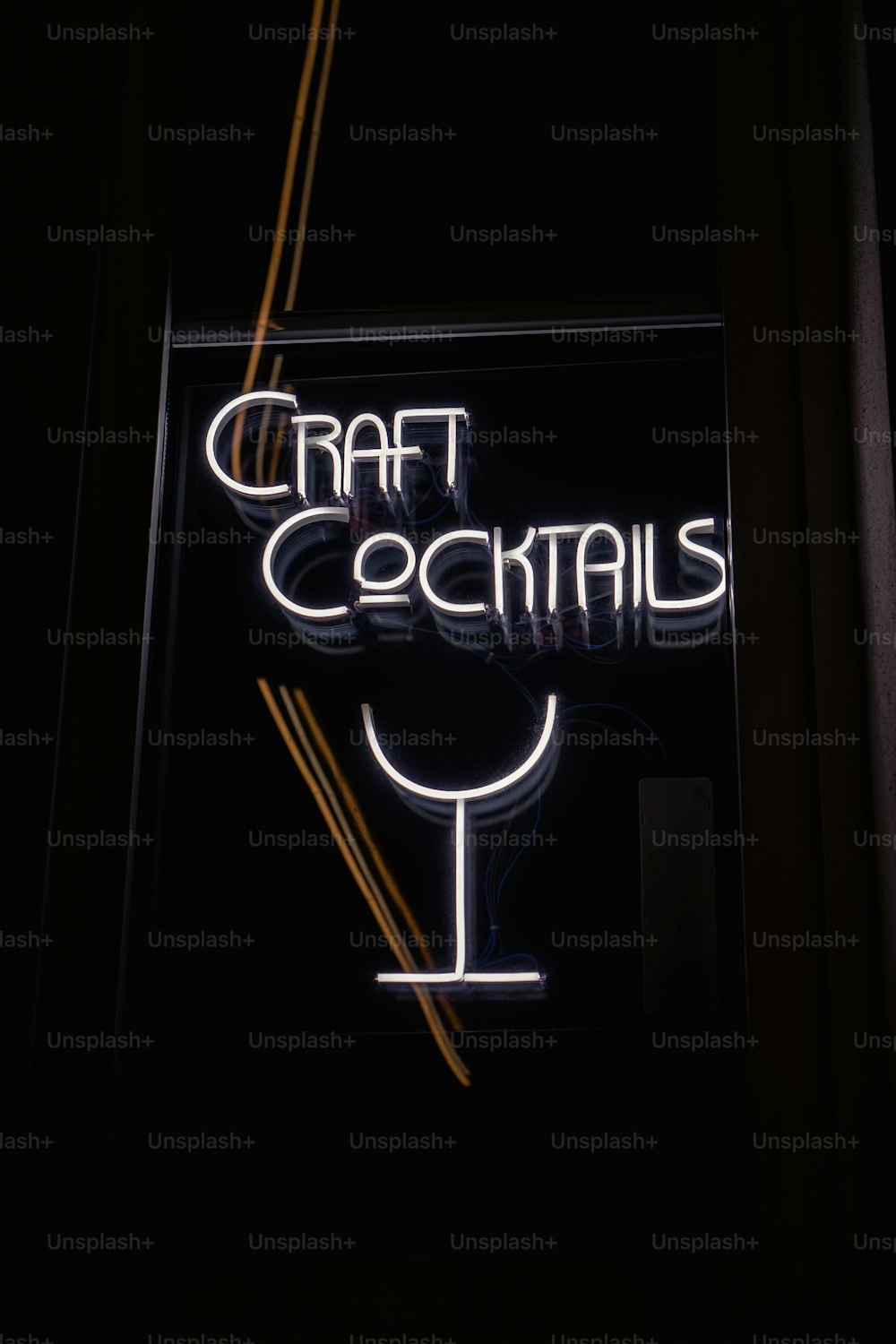 a neon sign that reads craft cocktails