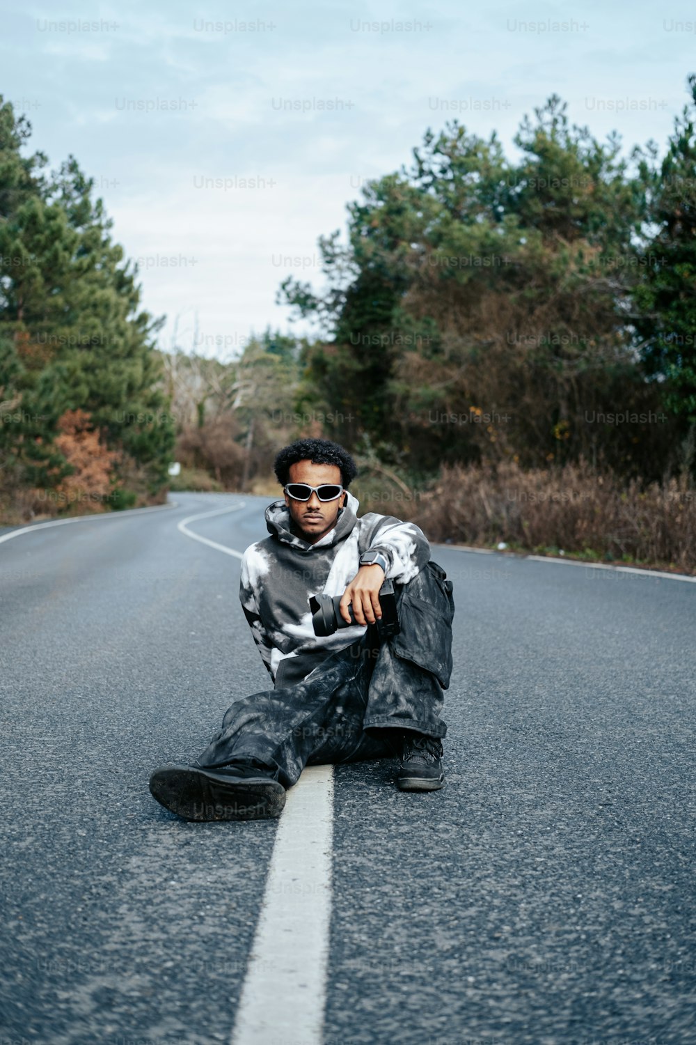 a man sitting on the side of a road