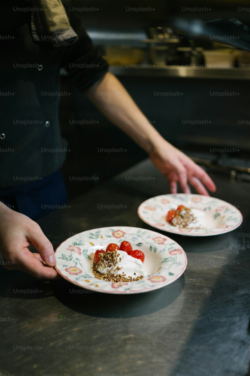 two plates with food on them being held by a person